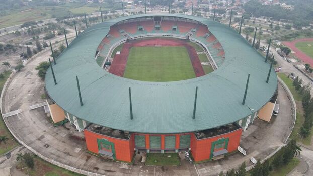 Aerial view of Pakansari Stadium featuring its distinctive green roof and oval architecture with a central grass pitch and running track in Kecamatan Cibinong Jawa Barat Indonesia. Aerial view of Pakansari Stadium featuring its distinctive green roof and oval architecture with a central grass pitch and running track in Kecamatan Cibinong Jawa Barat Indonesia.