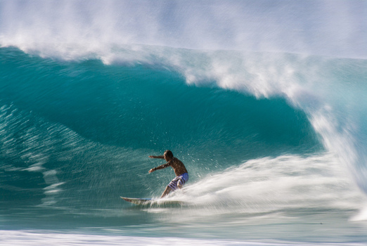 View of a surfer riding a massive powerful barrel wave at the Banzai Pipeline Haleiwa Hawaii United States.