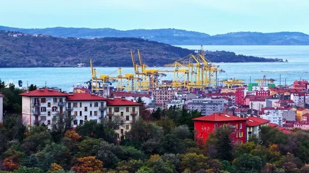 Aerial view of the industrial port and coastal city in Italy.