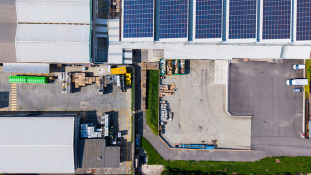 Aerial view of a waste processing facility with solar panels on the roof organized storage areas and industrial vehicles in Milan Lombardy Italy. Aerial view of a waste processing facility with solar panels on the roof organized storage areas and industrial vehicles in Milan Lombardy Italy.