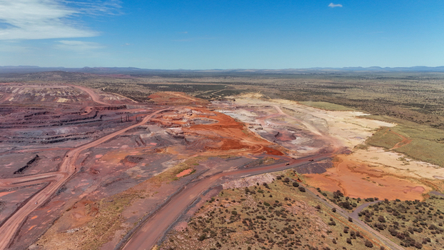 Aerial view of the land scarred with deep red earth and carved paths under a bright sky South Africa Africa. Aerial view of the land scarred with deep red earth and carved paths under a bright sky South Africa Africa.