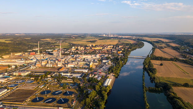 Aerial view of the Security Paper Mill industrial complex situated along the Elbe River with surrounding agricultural fields and chimneys in Steti Ustecky kraj Czechia. Aerial view of the Security Paper Mill industrial complex situated along the Elbe River with surrounding agricultural fields and chimneys in Steti Ustecky kraj Czechia.