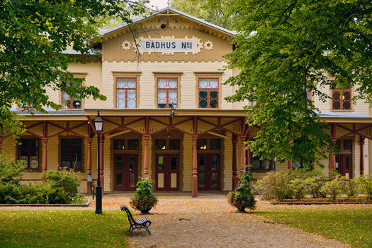 Ronneby Blekinge County Sweden 12 September 2025 View of the historic Badhus No 1 in Brunssparken featuring yellow wooden architecture ornate trim and lush park greenery. Ronneby Blekinge County Sweden 12 September 2025 View of the historic Badhus No 1 in Brunssparken featuring yellow wooden architecture ornate trim and lush park greenery.