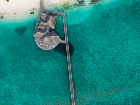 Aerial view of the vibrant turquoise waters contrast with the pristine white sands and thatched roof bungalows Hoarafushi Thiladhunmathee Uthuruburi Maldives. Aerial view of the vibrant turquoise waters contrast with the pristine white sands and thatched roof bungalows Hoarafushi Thiladhunmathee Uthuruburi Maldives.