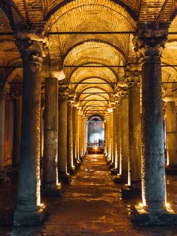 Istanbul Turkiye 07 October 2019 View of the Basilica Cistern s ancient columns reflecting in the still water bathed in warm golden light creating a mesmerizing subterranean ambiance.