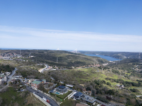 View of the hilly landscape and residential areas with the Bosphorus and Yavuz Sultan Selim Bridge in the distance in Sariyer Istanbul Turkiye.