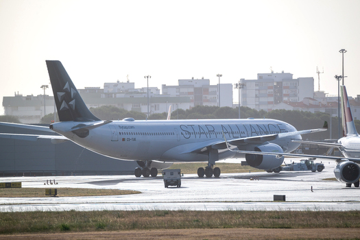 Lisboa Portugal 10 May 2026 View of a Star Alliance airplane on the tarmac at Humberto Delgado Airport with city buildings in the background. Lisboa Portugal 10 May 2026 View of a Star Alliance airplane on the tarmac at Humberto Delgado Airport with city buildings in the background.