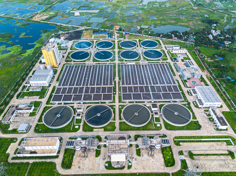 Aerial view of the Sewage Treatment Plant Dhaka WASA featuring circular clarifiers and industrial infrastructure surrounded by green fields in Dhaka Dhaka Division Bangladesh. Aerial view of the Sewage Treatment Plant Dhaka WASA featuring circular clarifiers and industrial infrastructure surrounded by green fields in Dhaka Dhaka Division Bangladesh.