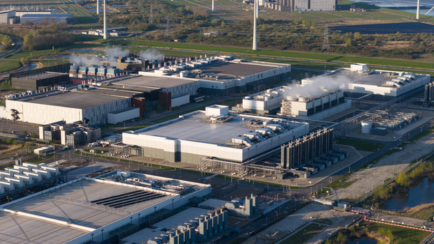 Drone view of a hyperscale data center in Eemshaven showing cloud computing server infrastructure cooling systems backup power and digital connectivity. Drone view of a hyperscale data center in Eemshaven showing cloud computing server infrastructure cooling systems backup power and digital connectivity.