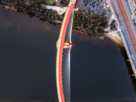 Aerial view of Boorloo Bridge with its distinctive red pedestrian path and cable stayed structure spanning the Swan River in East Perth Western Australia Australia.