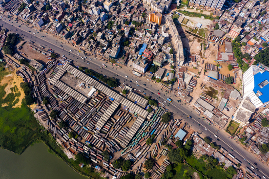 Aerial view of Gabtoli Bus Terminal showing rows of parked buses busy roads and dense urban development in Dhaka Dhaka Division Bangladesh.