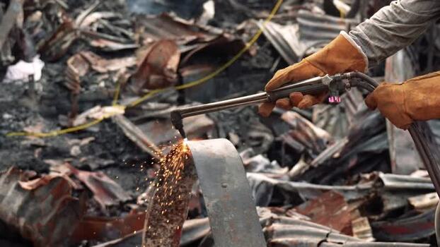 View of a worker cutting scrap metal with a torch Bangladesh. View of a worker cutting scrap metal with a torch Bangladesh.