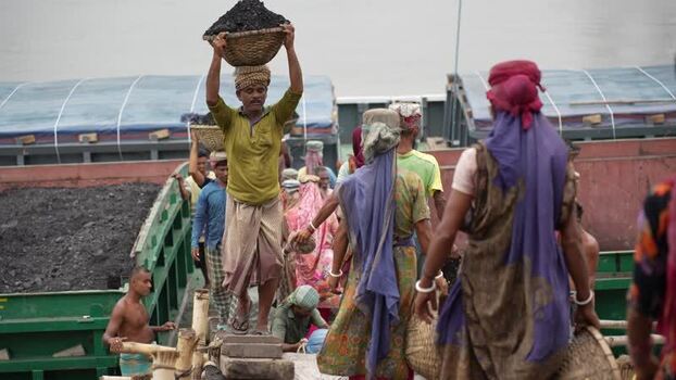 View of workers carrying coal baskets at Aminbazar Bangladesh.