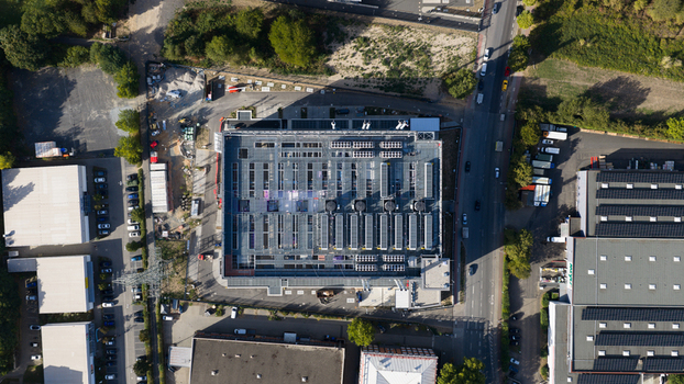 Aerial view of the Sossenheim datacenters featuring industrial rooftops with cooling units and solar panels surrounded by roads and green spaces in Frankfurt am Main Hessen Germany. Aerial view of the Sossenheim datacenters featuring industrial rooftops with cooling units and solar panels surrounded by roads and green spaces in Frankfurt am Main Hessen Germany.