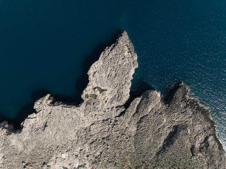 Aerial view of the jagged limestone cliffs and deep blue waters of the Plemmirio Marine Protected Area Plemmirio Sicily Italy. Aerial view of the jagged limestone cliffs and deep blue waters of the Plemmirio Marine Protected Area Plemmirio Sicily Italy.