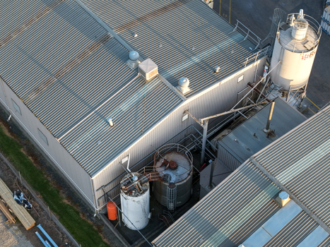 Melbourne VIC Australia 22 September 2026 Aerial view of industrial factory buildings with metal roofs and storage silos in Kilsyth showcasing the manufacturing district infrastructure. Melbourne VIC Australia 22 September 2026 Aerial view of industrial factory buildings with metal roofs and storage silos in Kilsyth showcasing the manufacturing district infrastructure.