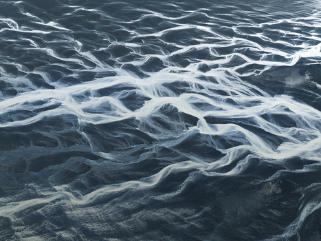 Aerial view of the ocean s surface a symphony of rippling waves reflecting light creating a mesmerizing dance of blues and whites Iceland Iceland. Aerial view of the ocean s surface a symphony of rippling waves reflecting light creating a mesmerizing dance of blues and whites Iceland Iceland.
