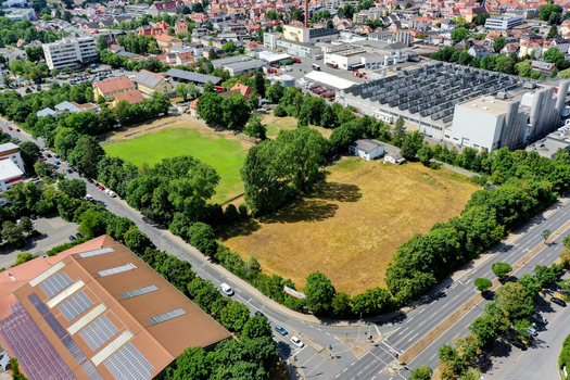 Aerial view of the SpVgg Jahn Forchheim Jugendabteilung sports grounds with green fields industrial warehouses and residential rooftops in Forchheim Bayern Germany. Aerial view of the SpVgg Jahn Forchheim Jugendabteilung sports grounds with green fields industrial warehouses and residential rooftops in Forchheim Bayern Germany.