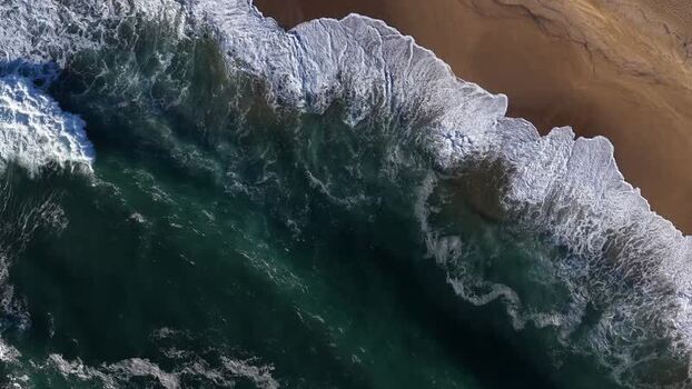 Aerial view of shoreline with dark water Portugal.