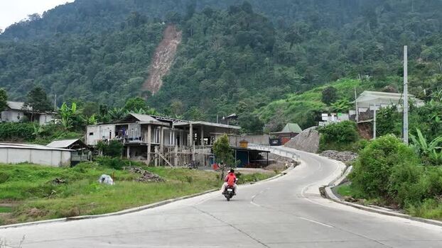 Aerial view of a winding road and lush green hills Indonesia.