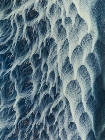 Aerial view of glacial rivers weaving intricate patterns across the stark landscape where icy blues meet earthy browns in a mesmerizing dance Iceland. Aerial view of glacial rivers weaving intricate patterns across the stark landscape where icy blues meet earthy browns in a mesmerizing dance Iceland.
