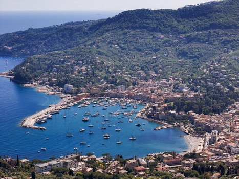 Aerial view of the harbor and colorful buildings of Santa Margherita Ligure nestled between the blue sea and lush green hills in Santa Margherita Ligure Liguria Italy. Aerial view of the harbor and colorful buildings of Santa Margherita Ligure nestled between the blue sea and lush green hills in Santa Margherita Ligure Liguria Italy.