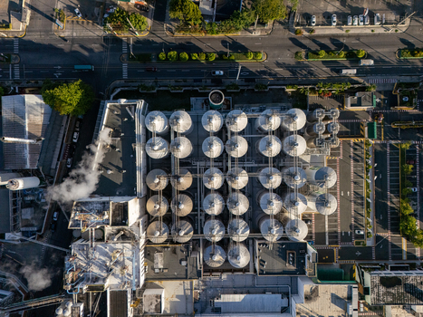 Aerial view of a beer industrial complex with rows of large metallic storage tanks industrial buildings and steam rising from vents in Santo Domingo Dominican Republic. Aerial view of a beer industrial complex with rows of large metallic storage tanks industrial buildings and steam rising from vents in Santo Domingo Dominican Republic.