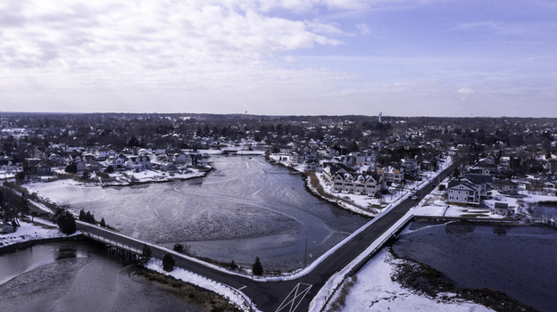 Aerial view of the frozen waterway and snow covered residential area in Manasquan New Jersey United States. Aerial view of the frozen waterway and snow covered residential area in Manasquan New Jersey United States.