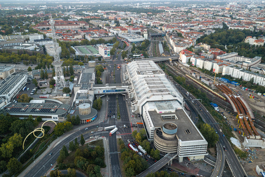 Aerial view of the ICC Berlin a prominent example of Brutalist architecture surrounded by urban roads railway tracks and greenery in Berlin Berlin Germany. Aerial view of the ICC Berlin a prominent example of Brutalist architecture surrounded by urban roads railway tracks and greenery in Berlin Berlin Germany.