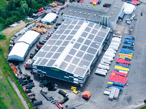 Jelgava Latvia 04 July 2026 Aerial view of the Evopipes manufacturing facility featuring large industrial buildings with solar panels on the roof and extensive outdoor storage of plastic pipes.
