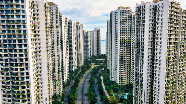 Aerial view of Forest City with modern high rise residential towers featuring vertical greenery on balconies surrounded by lush landscaping in Gelang Patah Johor Darul Ta zim Malaysia. Aerial view of Forest City with modern high rise residential towers featuring vertical greenery on balconies surrounded by lush landscaping in Gelang Patah Johor Darul Ta zim Malaysia.