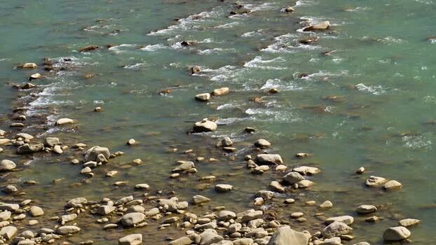 View of a rocky river with flowing turquoise water Nepal.