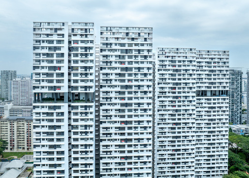 Aerial view of modern high rise residential apartment blocks with white facades and geometric balconies in Singapore Singapore. Aerial view of modern high rise residential apartment blocks with white facades and geometric balconies in Singapore Singapore.