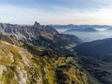 Aerial view of the Lunersee mountain lake surrounded by rugged Ratikon Alps peaks lush alpine meadows and rocky slopes in Vandans Vorarlberg Austria. Aerial view of the Lunersee mountain lake surrounded by rugged Ratikon Alps peaks lush alpine meadows and rocky slopes in Vandans Vorarlberg Austria.
