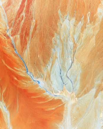 Aerial view of the abstract mineral patterns and vibrant orange sediment at the historic open pit mine Minas de Riotinto Andalusia Spain.