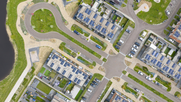 Aerial view of the modern Nobelhorst neighborhood featuring houses with solar panels on roofs green gardens and organized parking lots in Almere Flevoland Netherlands. Aerial view of the modern Nobelhorst neighborhood featuring houses with solar panels on roofs green gardens and organized parking lots in Almere Flevoland Netherlands.