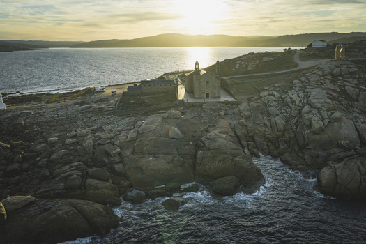 Aerial view of the Santuario da Virxe da Barca perched on the rocky coastline of Muxia Galicia Spain.