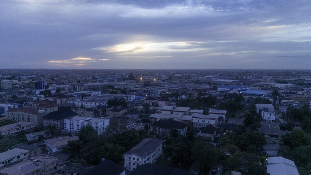 Aerial view of the urban landscape around Allen Avenue featuring dense residential buildings and lush trees under a cloudy twilight sky in Ikeja Lagos Nigeria. Aerial view of the urban landscape around Allen Avenue featuring dense residential buildings and lush trees under a cloudy twilight sky in Ikeja Lagos Nigeria.