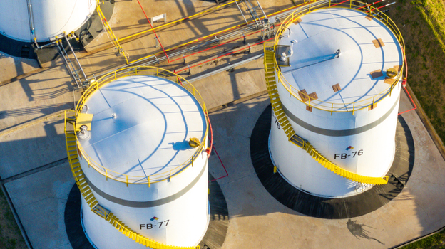 Aerial view of large industrial storage tanks with yellow spiral staircases and connecting pipes at a petrochemical complex in Santo Andre State of Sao Paulo Brazil.