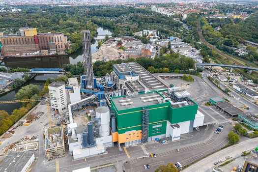 Aerial view of Klarwerk Ruhleben sewage treatment plant featuring colorful industrial buildings a tall chimney and surrounding greenery near the river Spree in Berlin Berlin Germany.