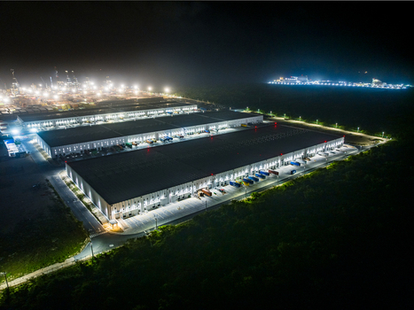 Aerial view of Caucedo Logistics Center at night featuring illuminated warehouse buildings loading docks with trucks and bright floodlights in Andres Santo Domingo Dominican Republic. Aerial view of Caucedo Logistics Center at night featuring illuminated warehouse buildings loading docks with trucks and bright floodlights in Andres Santo Domingo Dominican Republic.