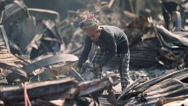 View of a man searching through debris in Dhaka Bangladesh. View of a man searching through debris in Dhaka Bangladesh.