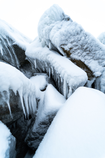 View of ice covered rocks and icicles on the breakwater near the Molenfeuer Sassnitz Sassnitz Mecklenburg Vorpommern Germany.