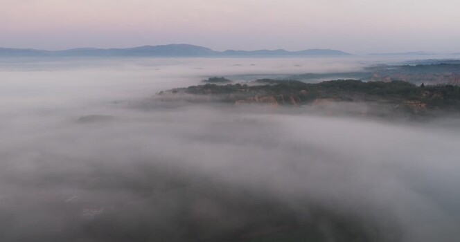 Aerial view of Balze del Valdarno rock formations in thick mist Italy. Aerial view of Balze del Valdarno rock formations in thick mist Italy.