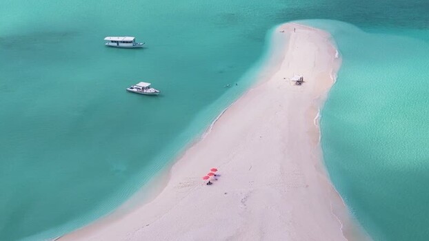 Aerial view of a tropical sandbar with boats in the turquoise sea Maldives. Aerial view of a tropical sandbar with boats in the turquoise sea Maldives.