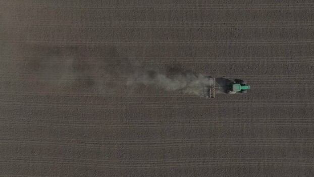 Aerial view of a tractor working in a field Portugal. Aerial view of a tractor working in a field Portugal.