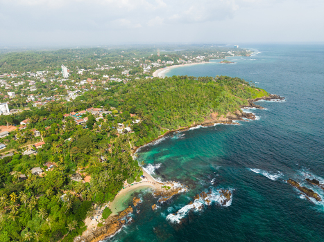 Aerial view of Secret Beach Mirissa with turquoise ocean water rocky shoreline and lush tropical greenery Mirissa Southern Province Sri Lanka. Aerial view of Secret Beach Mirissa with turquoise ocean water rocky shoreline and lush tropical greenery Mirissa Southern Province Sri Lanka.