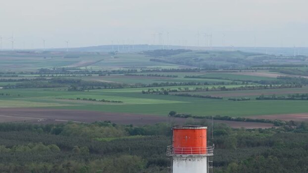 Aerial view of an industrial chimney and rolling fields Czechia. Aerial view of an industrial chimney and rolling fields Czechia.