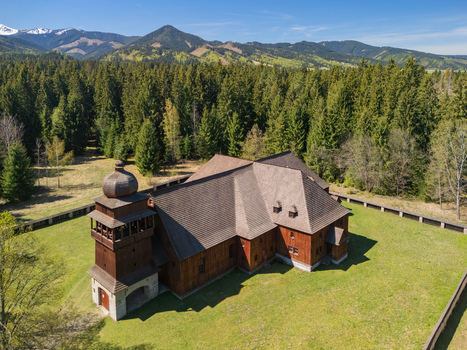 Aerial view of the Wooden Articular Church of Svaty Kriz with its dark timber walls and shingled roof surrounded by a lush forest in Svaty Kriz Zilinsky kraj Slovakia.