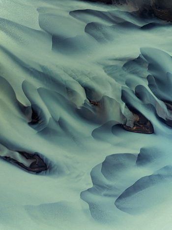 Aerial view of glacial river carves a path through the rugged terrain revealing the stark beauty of Iceland s natural landscapes Iceland Iceland. Aerial view of glacial river carves a path through the rugged terrain revealing the stark beauty of Iceland s natural landscapes Iceland Iceland.